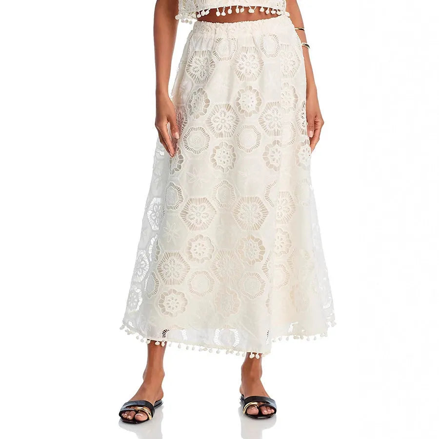 White women's sleeveless top and long skirt suit with embroidery detail