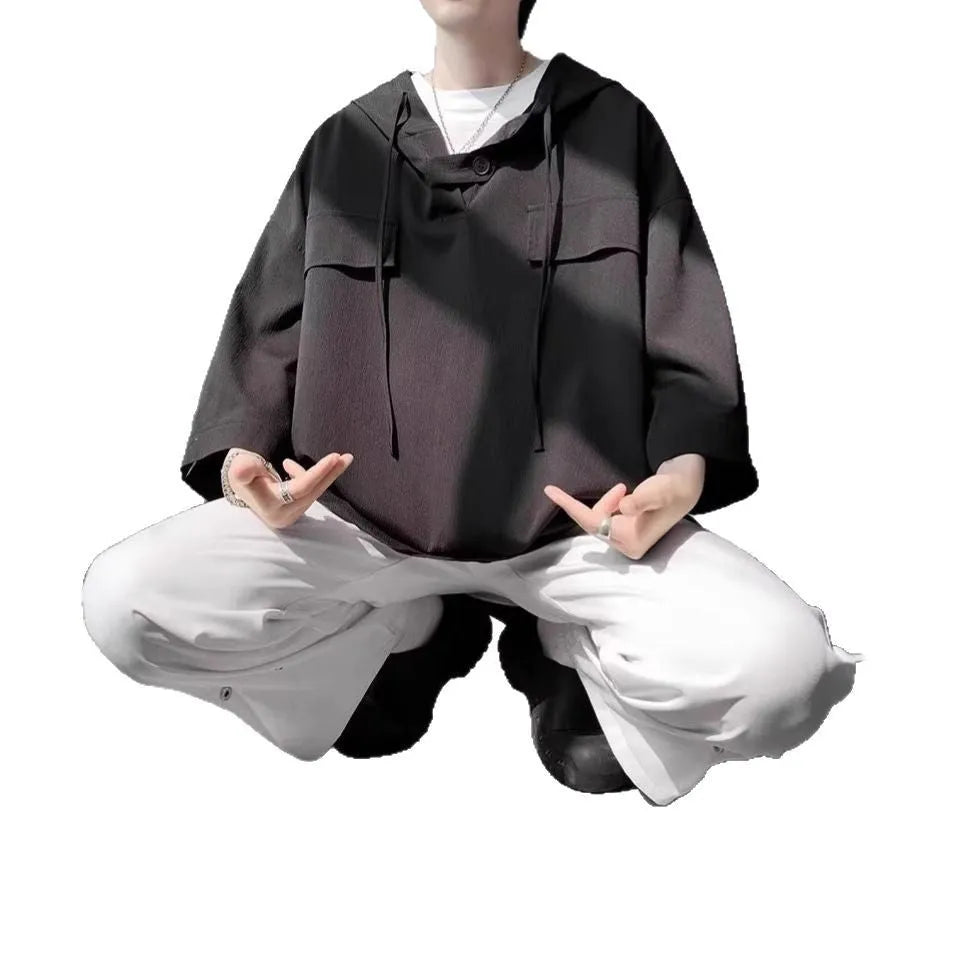 Man wearing black hooded short sleeve T-shirt with loose fit for summer casual wear