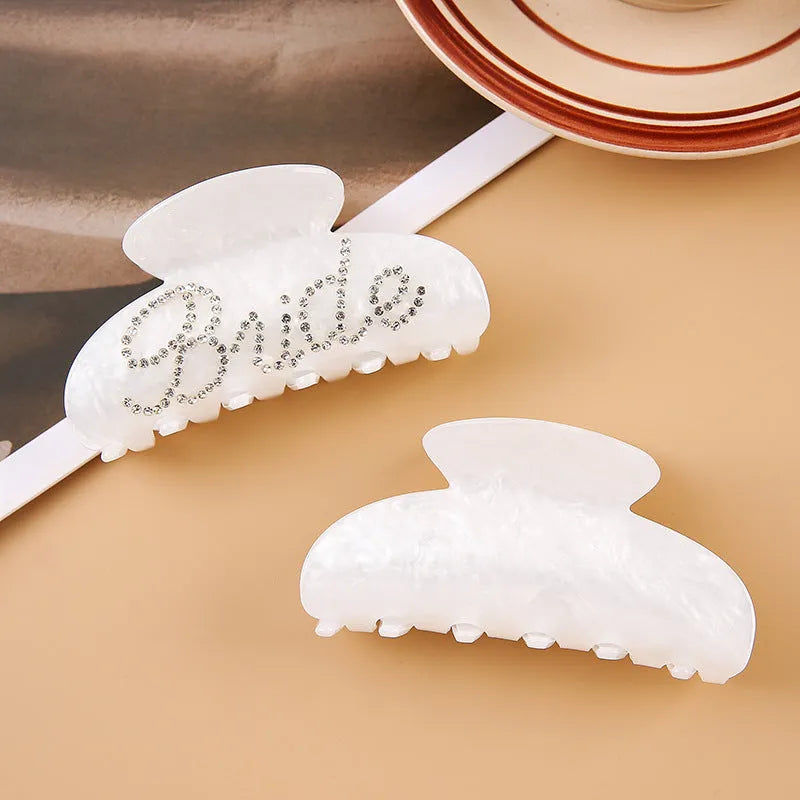Pink and white acrylic shark clip hair barrettes with spot drill decoration on a sweet style
