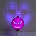 Plastic pumpkin lamp with USB port showing yellow and purple light options