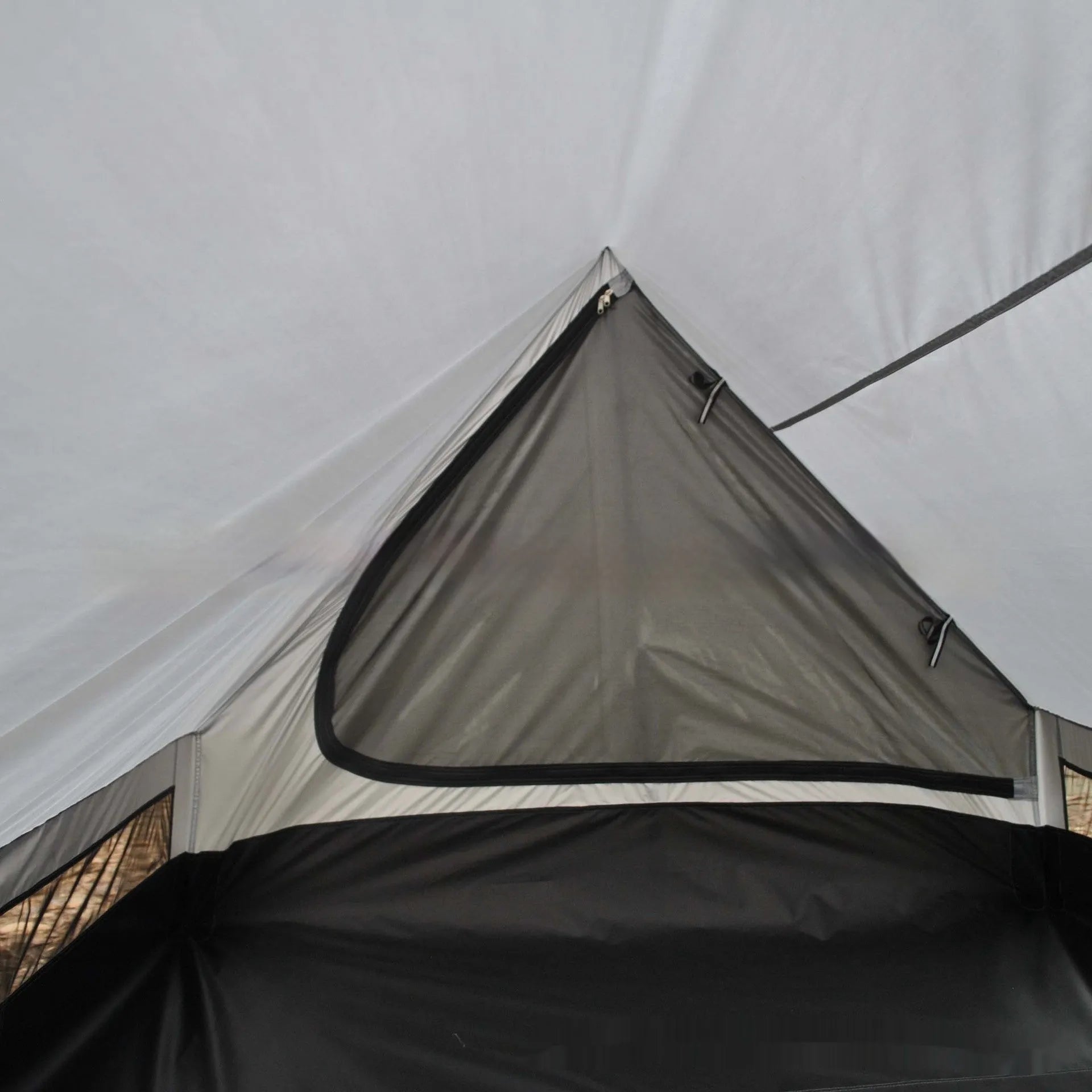 Brown A-line cabin tent setup with hiking pole supports showing spacious interior and waterproof fabric construction
