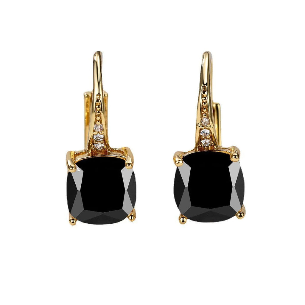 Geometric copper ear hook with round element and inlaid square zircon stone, shown in a golden colour.