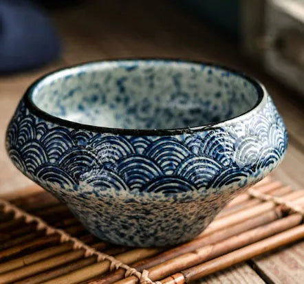 Ceramic tall Japanese soup noodle bowl in a retro glaze colour on a wooden table.