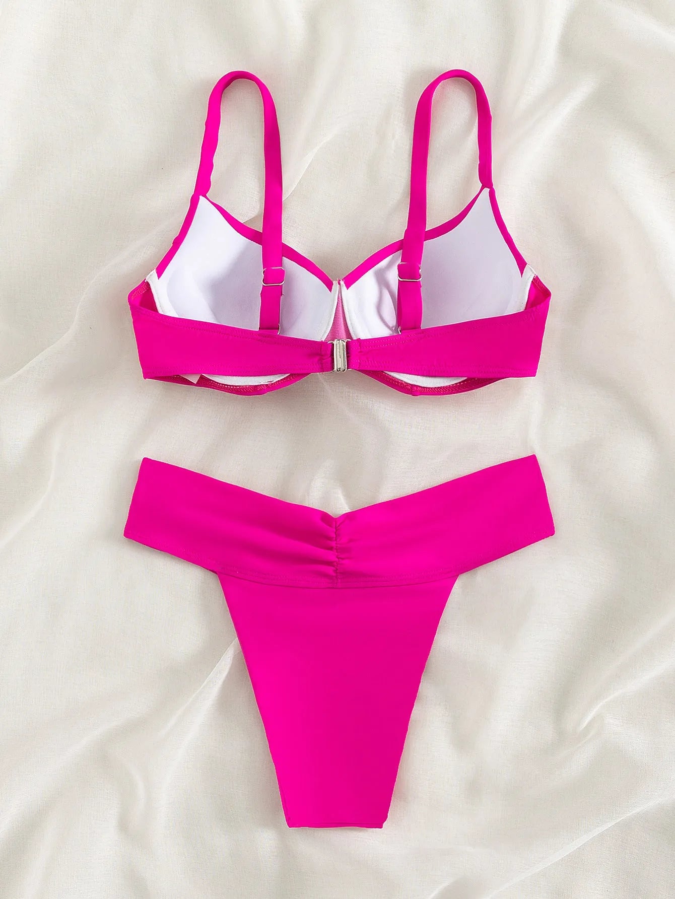 Solid colour bikini swimsuit in fluorescent pink, green, blue, orange, or black, showing sleeveless top and split briefs.