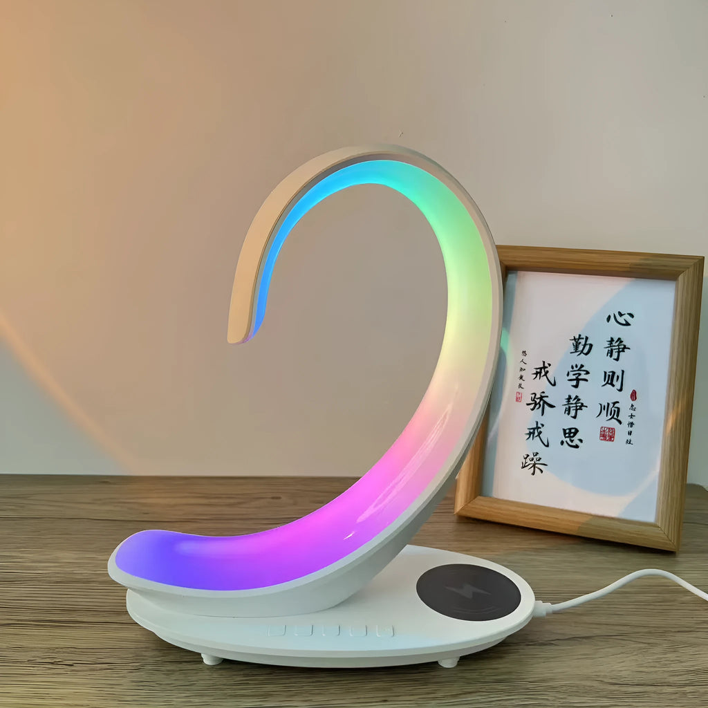 White swan-shaped desktop wireless charger with Bluetooth speaker and colourful atmosphere light