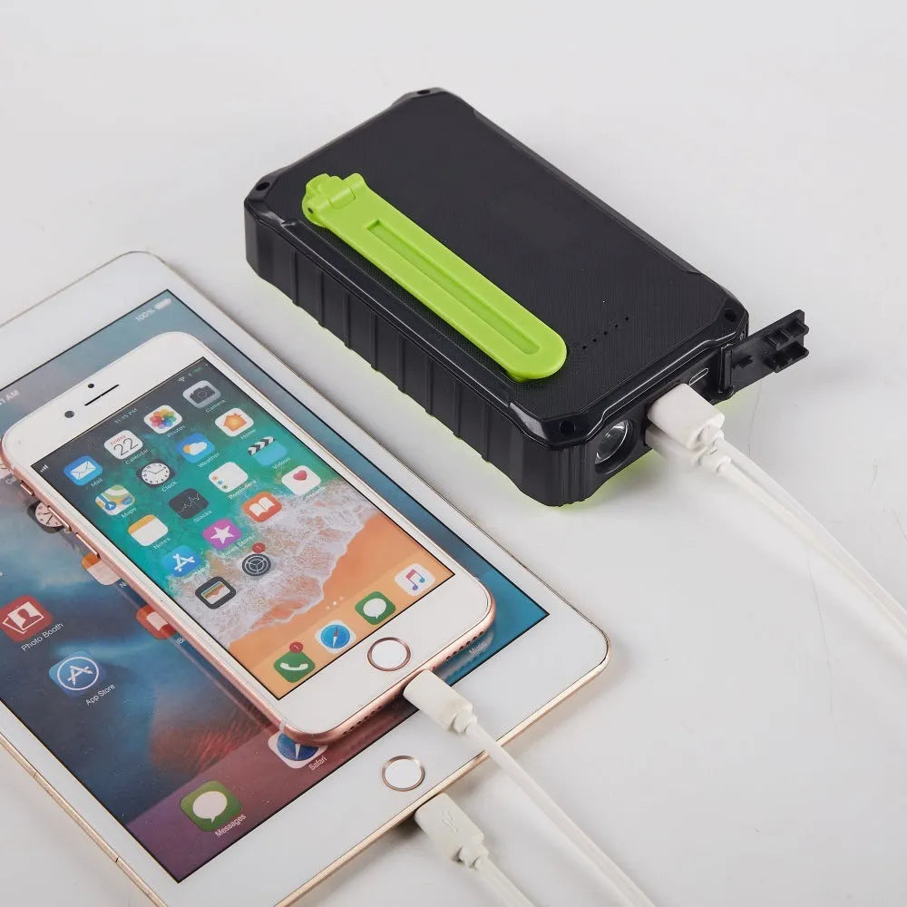 Orange and green hand crank solar power bank with 12000mAh capacity, dual USB ports, and a solar panel.