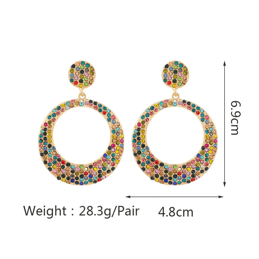 Large circular pendant earrings with diamond accents in colourful cartoon style design