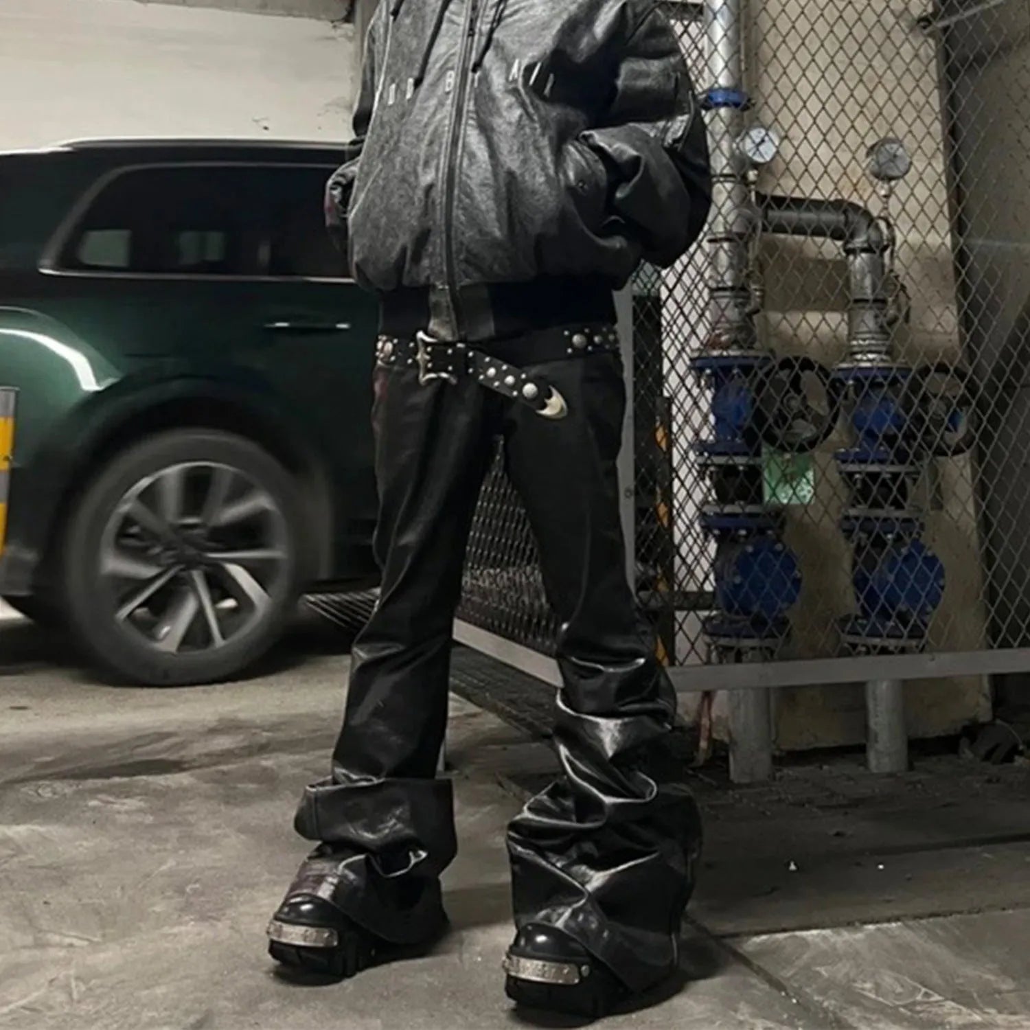 Black coated patent leather straight-leg skinny jeans on a hanger
