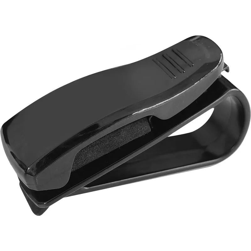 Black plastic car sun visor clip organiser for glasses and cards on a car interior.