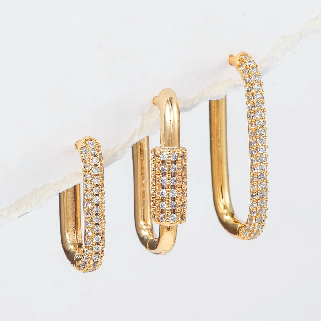 Geometric ear clips set with micro inlaid zircon detailing on copper, showing ellipse and quadrilateral shapes in gold and white finishes
