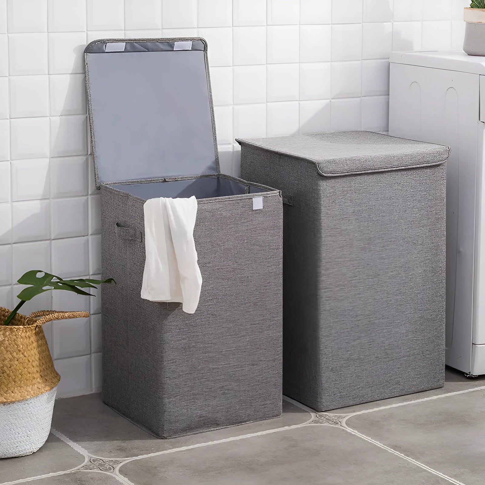 Grey foldable cotton linen storage basket shown next to a folded towel and a book.