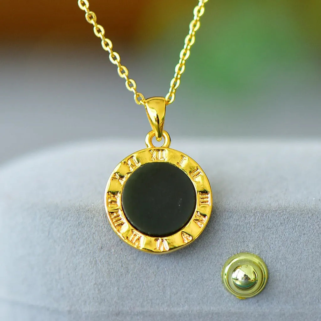 Flat grey Hetian jade pendant with copper metal inlay and small ink blue jade accents on a necklace chain.