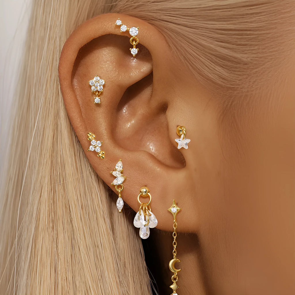S925 sterling silver geometric moon and embedded star piercing earrings on a gold-colour background.
