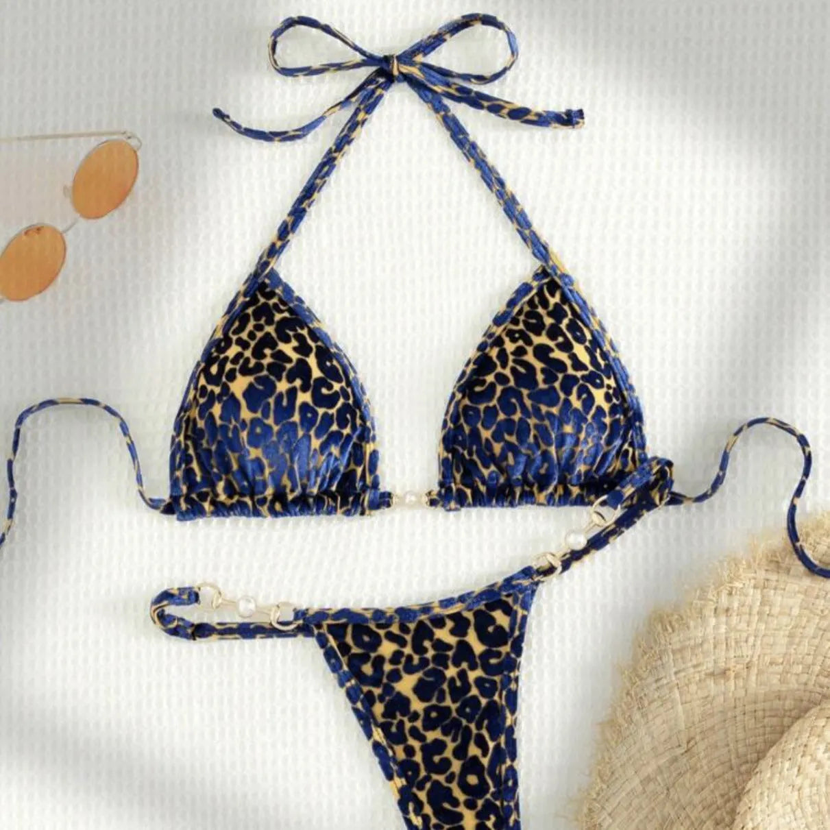 Blue and green leopard print women's bikini set on a mannequin, showing T-shaped design.
