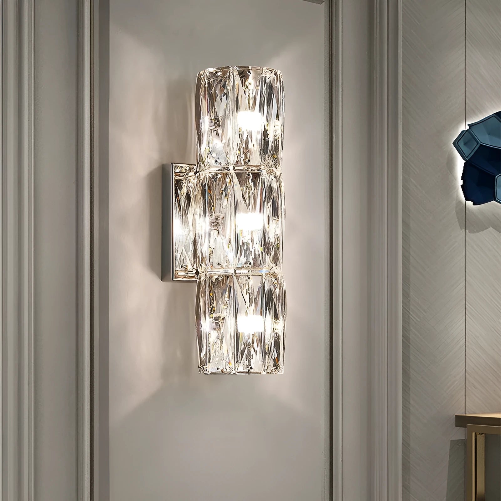 Crystal LED wall lamp with stainless steel frame in chrome finish showing tri-colour lighting