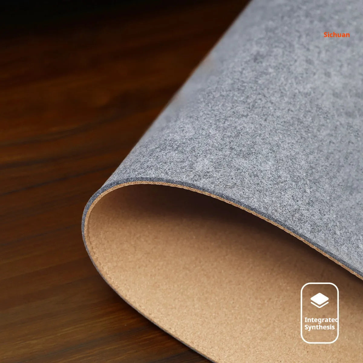 Oversized felt cork desk mouse mat in black and grey pattern, shown on a wooden desk.