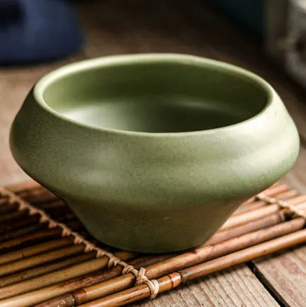 Ceramic tall Japanese soup noodle bowl in a retro glaze colour on a wooden table.