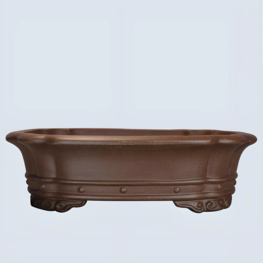Purple clay handmade rectangular antique flower pot on a desktop.