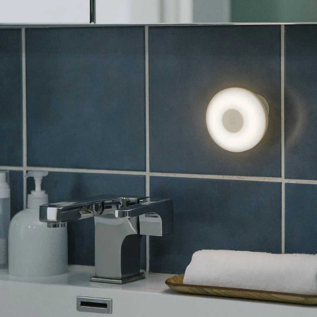 White square Mijia Night Light 2 Bluetooth bedside lamp with human body induction on wooden table