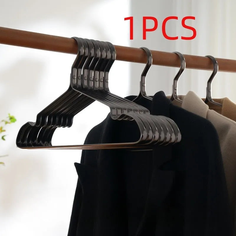A single elegant black non-slip clothes hanger on a white background.