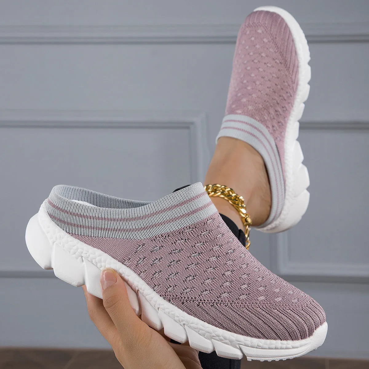 Women's black Flyknit socks semi slipper shoes with striped pattern and hollow-out design on a viscose sole.