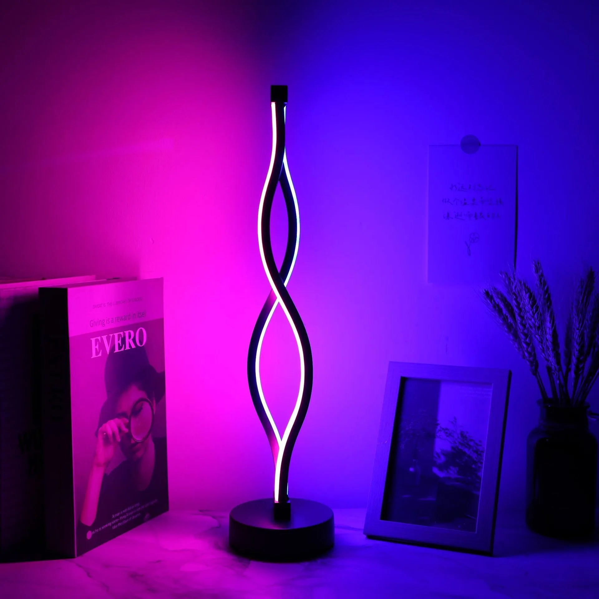 Black aluminium desk lamp with touch dimming controls and three-colour lighting options
