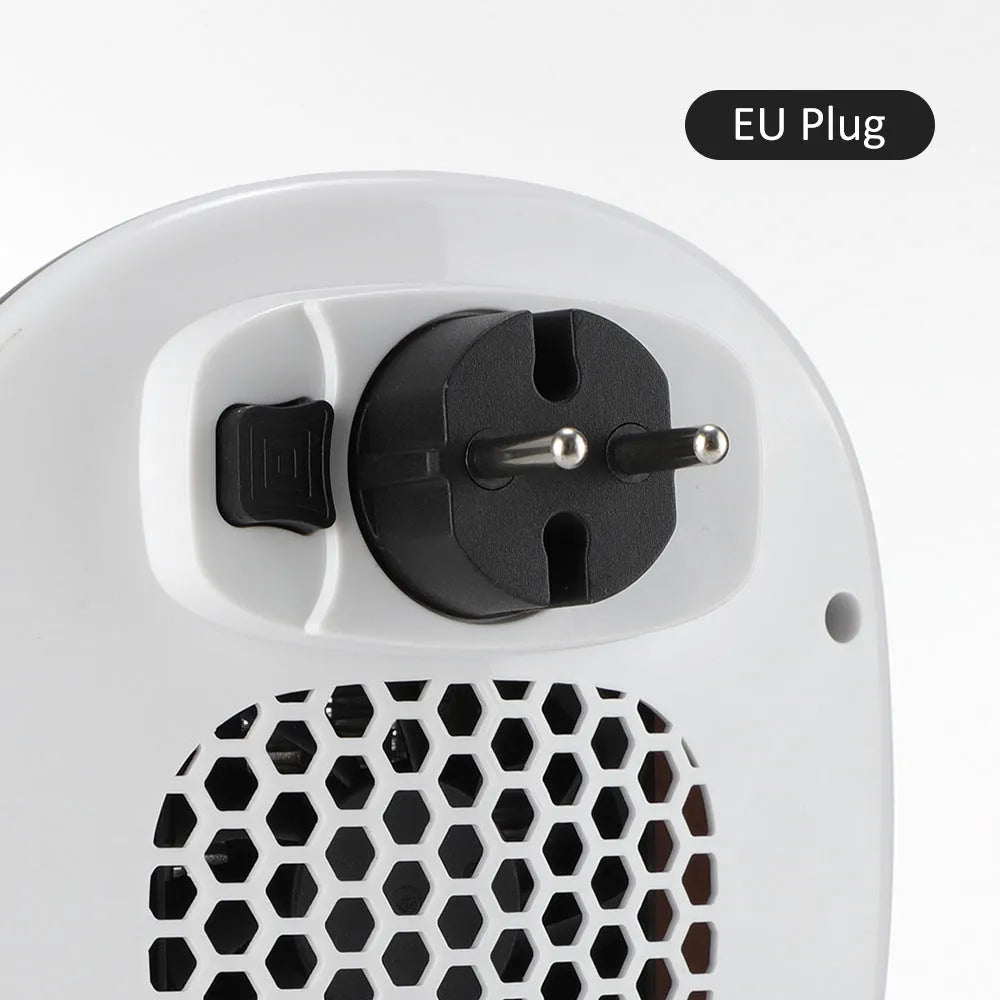 White portable ceramic electric fan heater with remote control on a table.