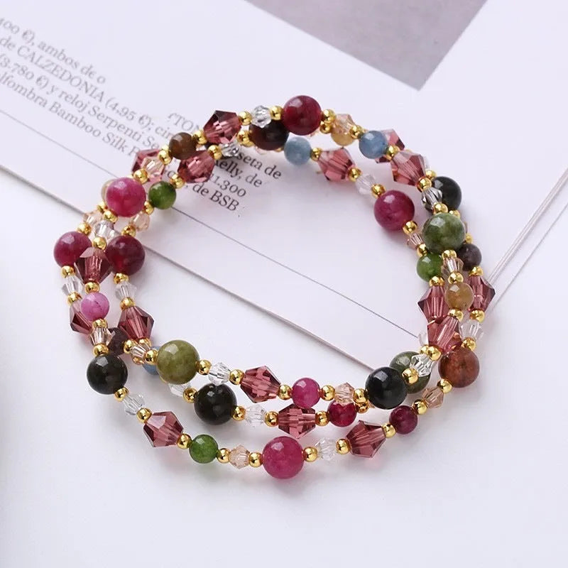 Women's adjustable bracelet with three rings of tourmaline, strawberry quartz or amethyst crystal beads on knotted cord