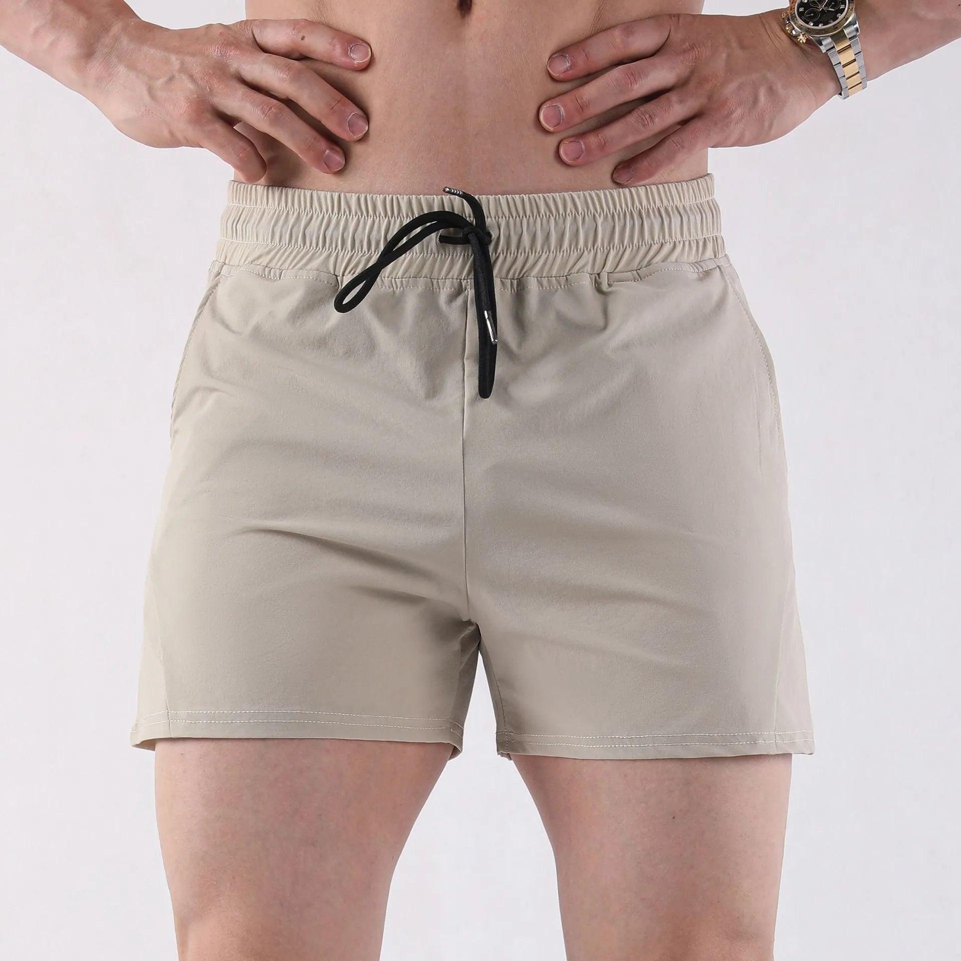 Men's thin grey polyester basketball shorts with an elastic waistband laid flat