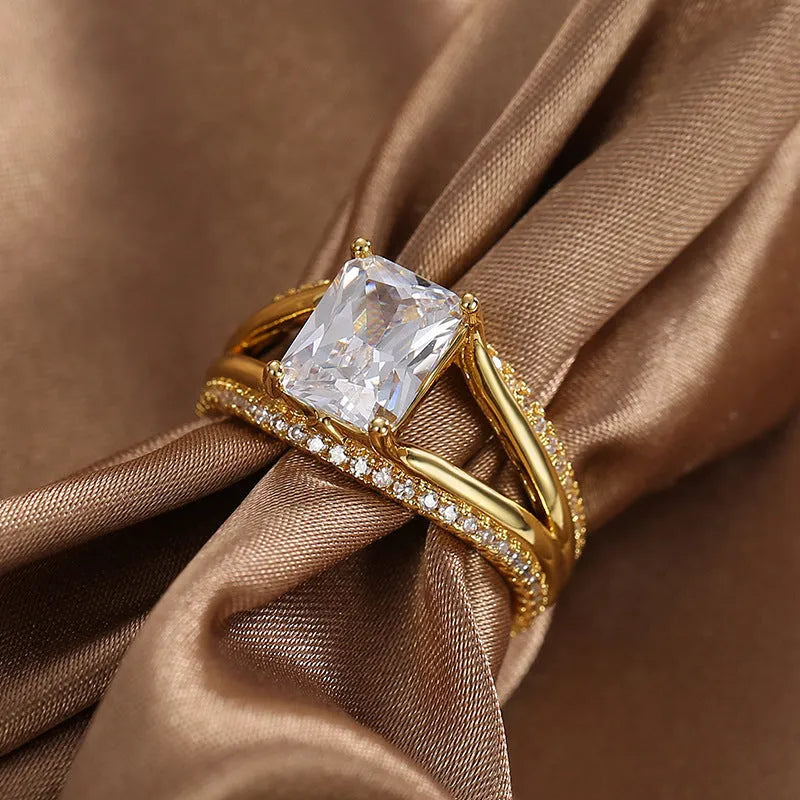 Gold-coloured geometric women's copper ring with a square zircon stone.