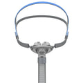Ventilator nasal pillow mask with silicone cushion and headband components displayed in English packaging
