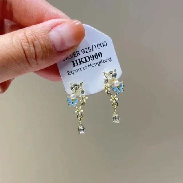 Geometric alloy clip-on earrings with rhinestone stars, a heart design, and dangling tassels.
