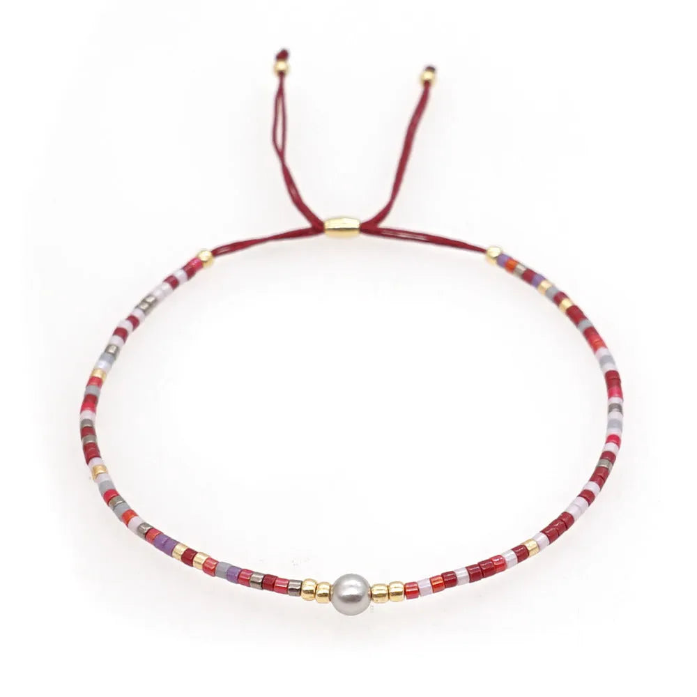 Handmade bohemian style bracelet with semi-precious stone and glass beads in geometric pattern