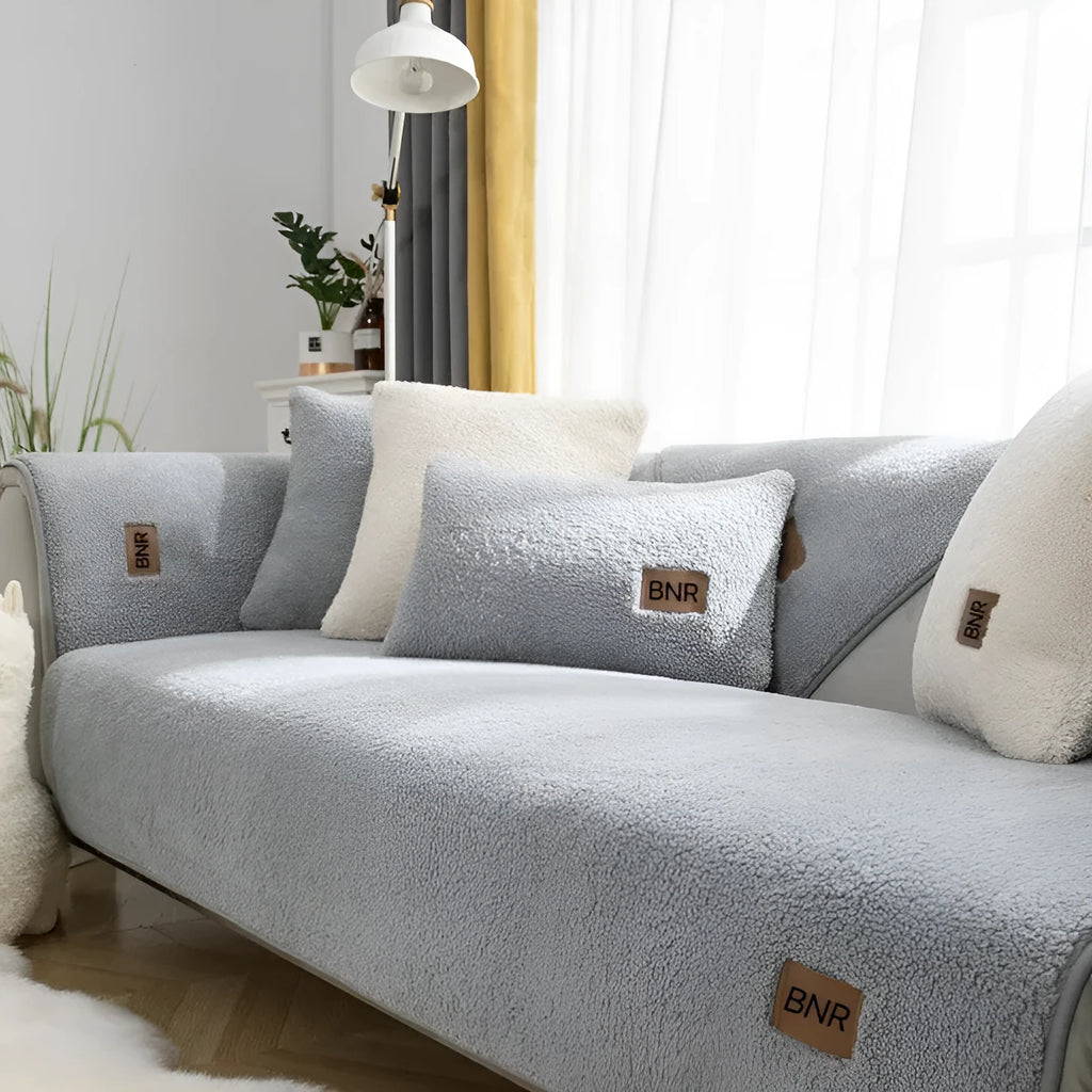 Lambswool solid colour sofa cover in blue on a three-seater sofa