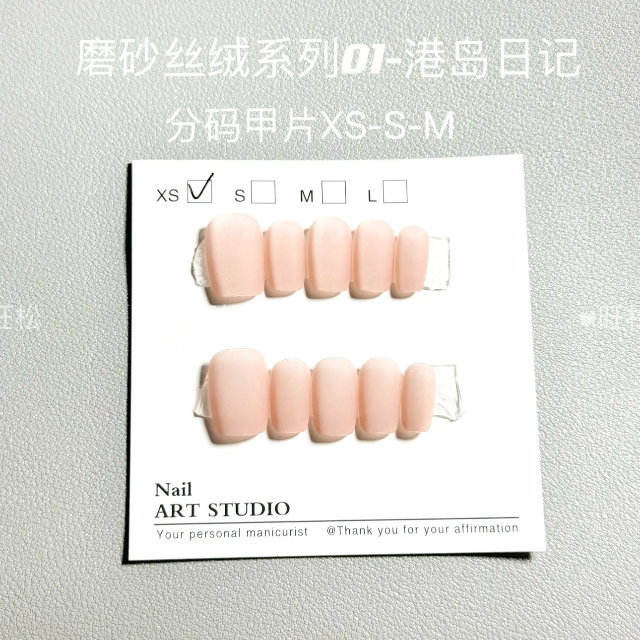 Set of frosted velvet false nails with Cat's Eye reflection in short ladder shapes on a display stand.