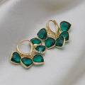 Pair of green heart-shaped glass pendant ear clip earrings with alloy and artificial gemstone details.