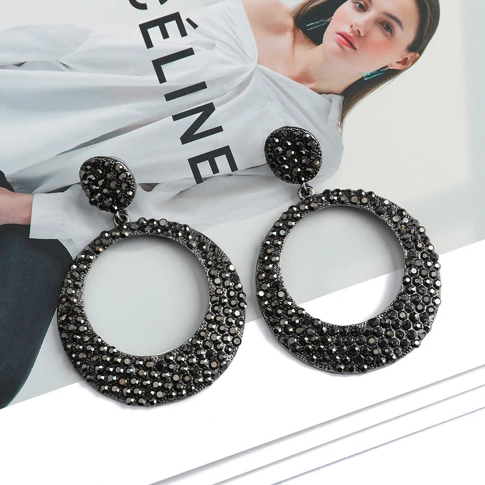 Large circular pendant earrings with diamond accents in colourful cartoon style design