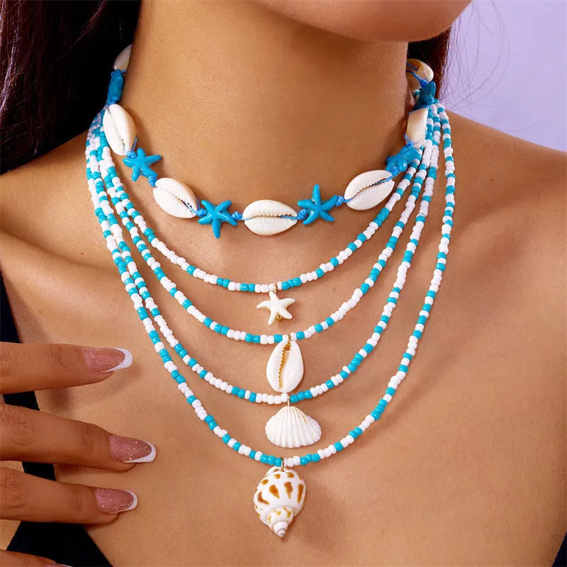Five women's necklaces with starfish, shell and conch bead pendants on adjustable chains