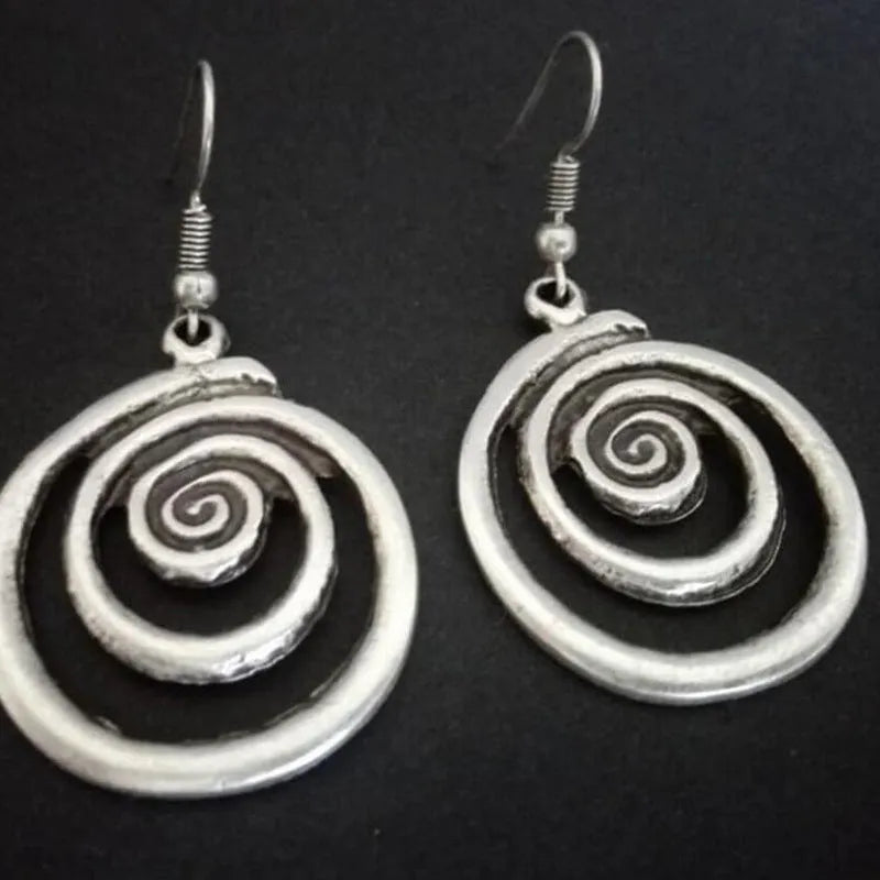Silver geometric spiral earrings with distressed finish and vintage ethnic style design