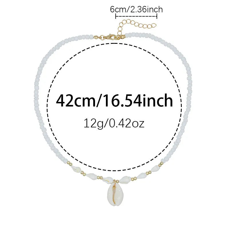 White conch shell necklace with mother of pearl pendant and beads on a chain.