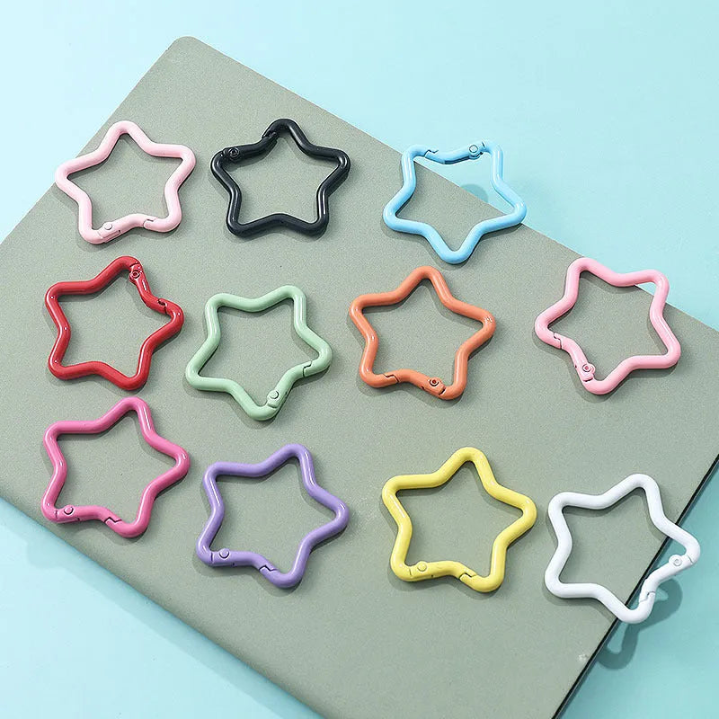 Zinc alloy five-pointed star keychain in assorted macaron colours including pink, blue, and purple