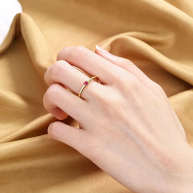 Copper geometric ring with a single diamond shape on a round band, shown in white, red, green, and blue colour options.