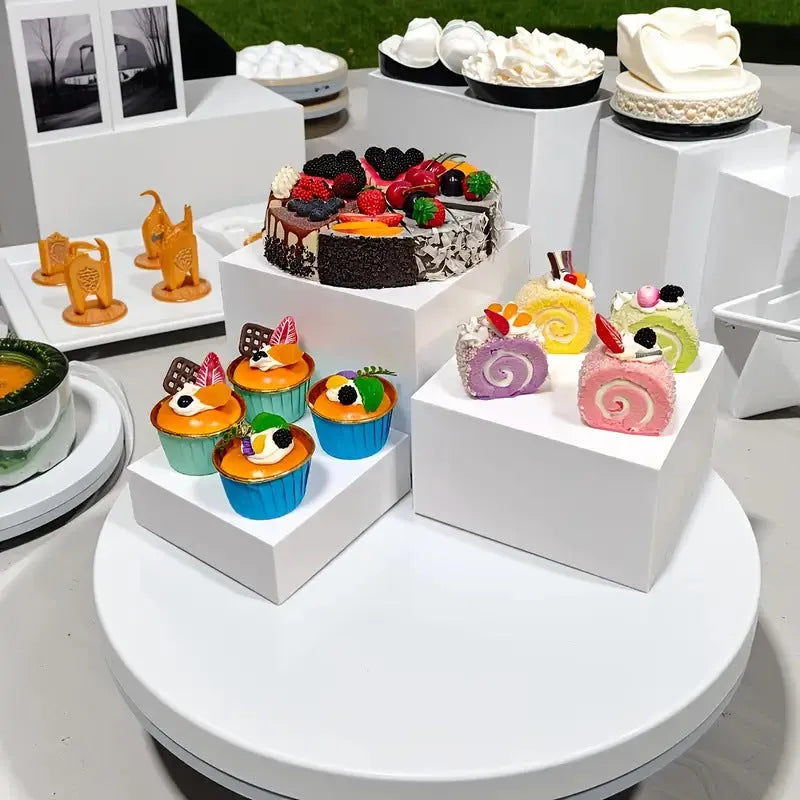 White and transparent plastic dessert display cube sets showing stackable 6-piece arrangements for cakes and pastries