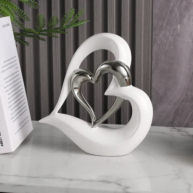 Modern white porcelain love heart ornament with geometric style on a table.