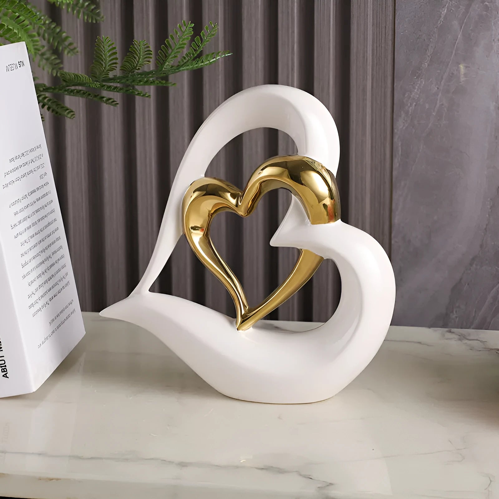 Modern white porcelain love heart ornament with geometric style on a table.
