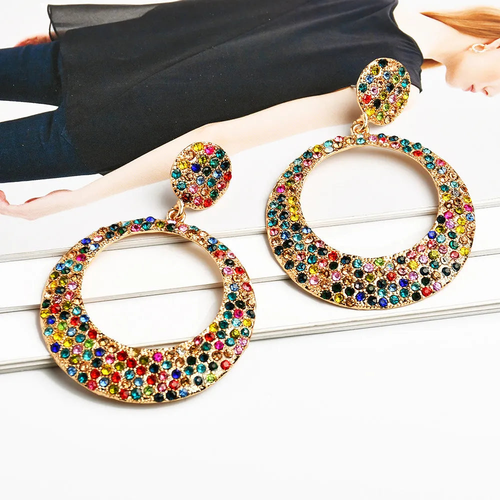 Large circular pendant earrings with diamond accents in colourful cartoon style design