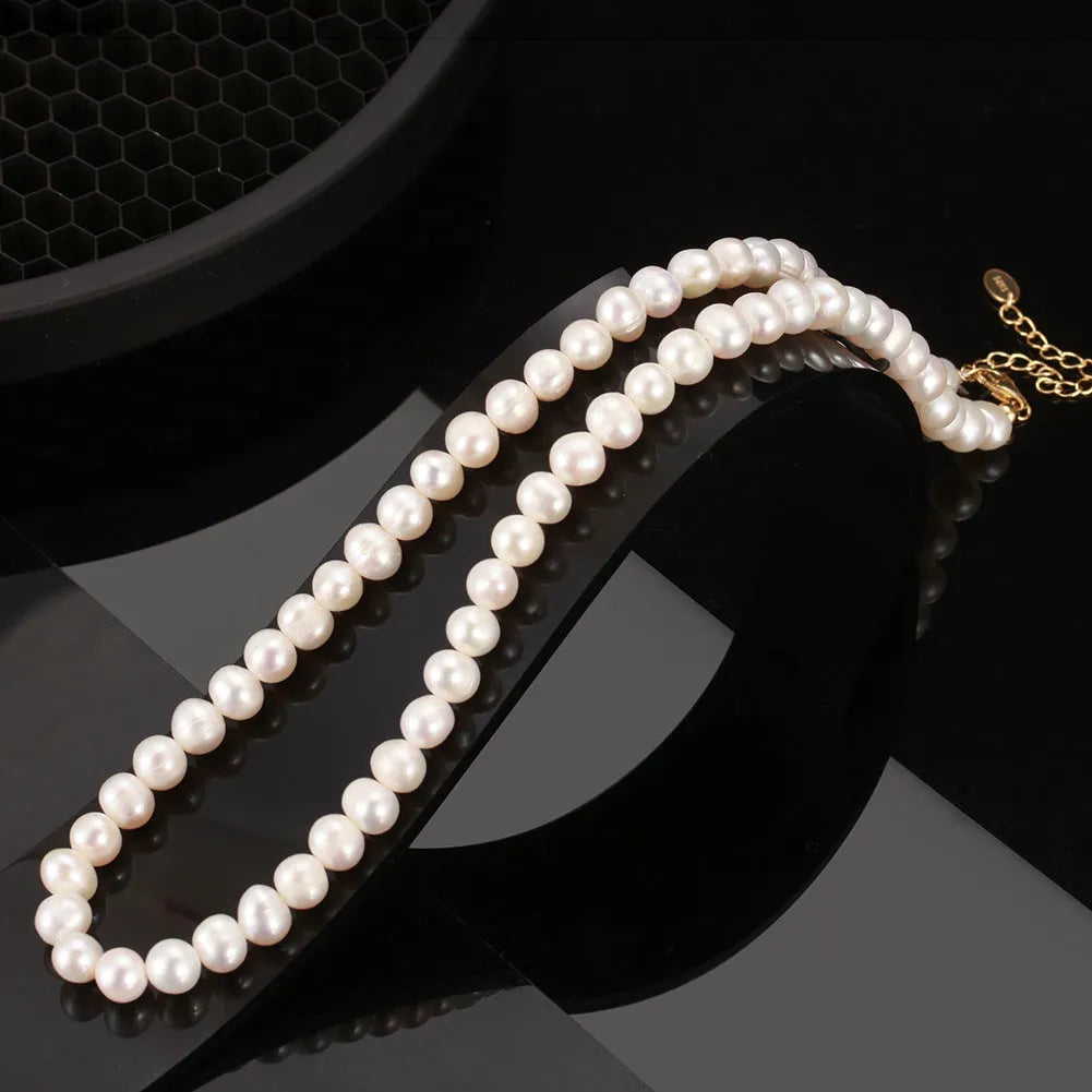 Women's freshwater pearl necklace with adjustable sterling silver chain showing 6-7mm natural pearls