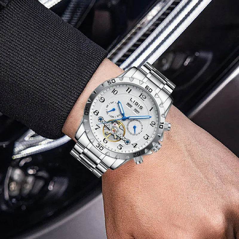 Men's silver stainless steel automatic perpetual calendar mechanical watch on wrist.