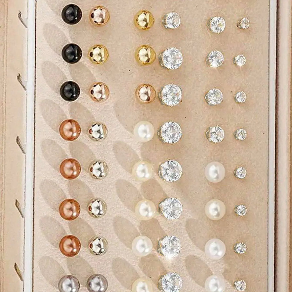 108 gold and yellow alloy stud earrings with geometric shapes and round pearl details on a plain surface.