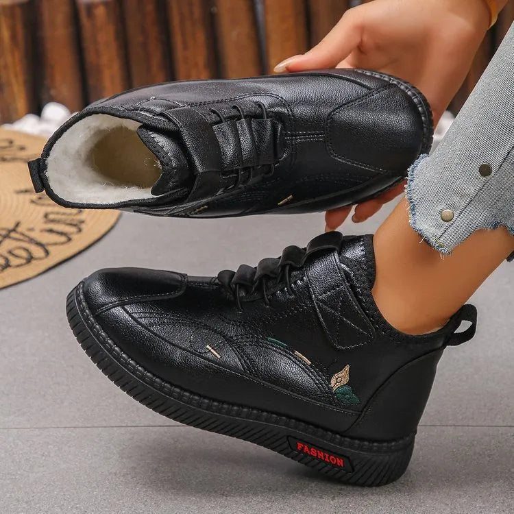 Women's black velvet slipper with hollow-out design and non-slip rubber sole.